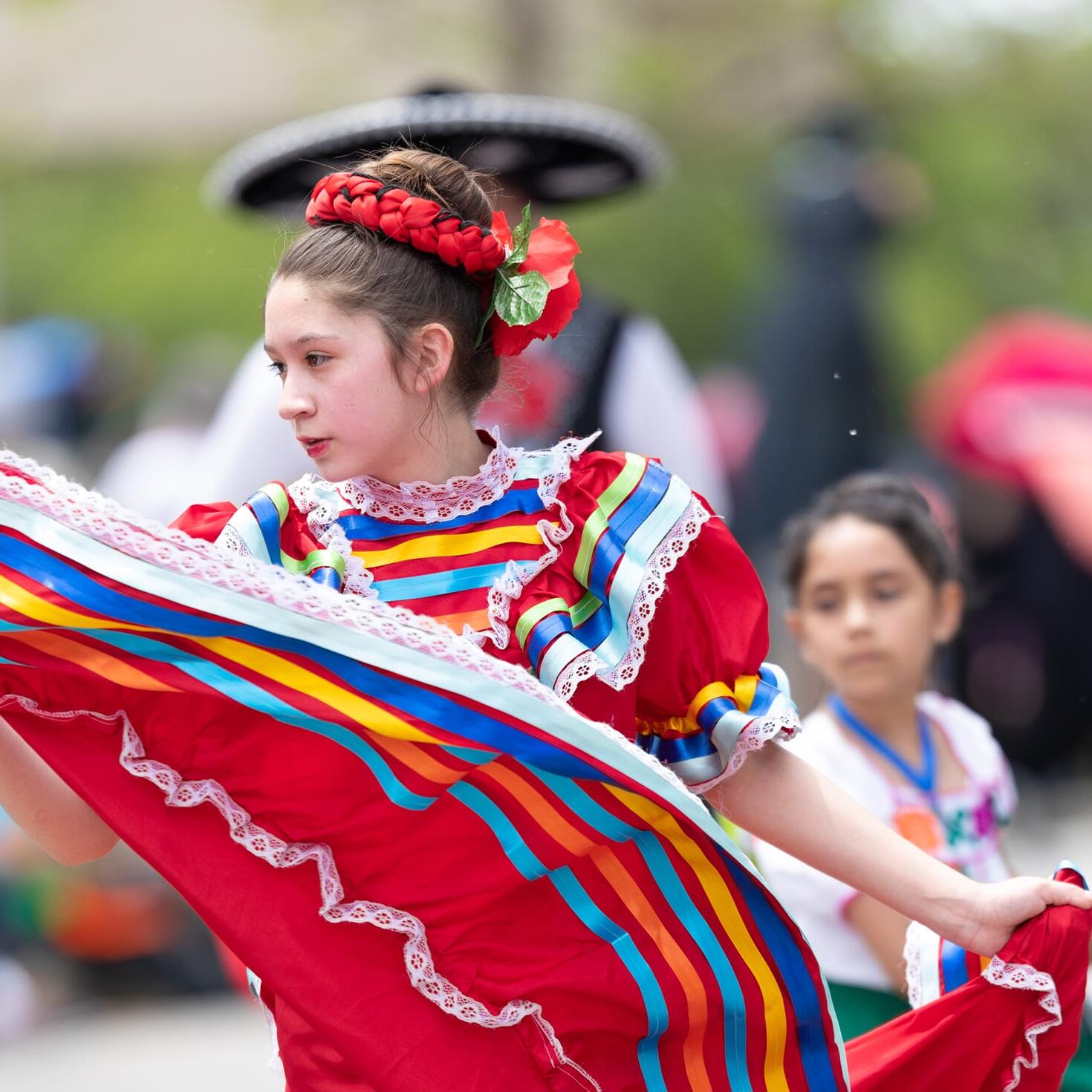 Cleveland, Ohio, USA - June 8, 2019: Parade the Circle, young woman wearing traditional mexican clothing dancing